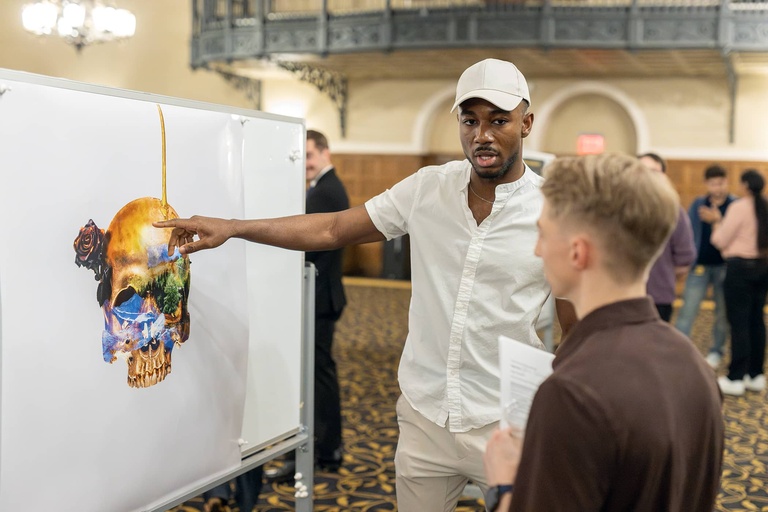 A graduate student presents their research at the 2025 Jakobsen Conference.